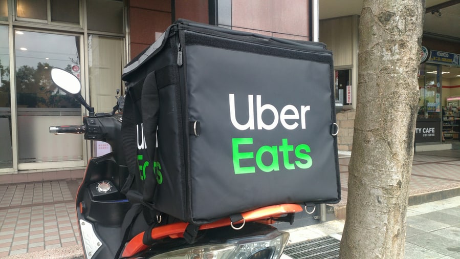 Uber Eats Motorcycle Parked In Front Of A Restaurant