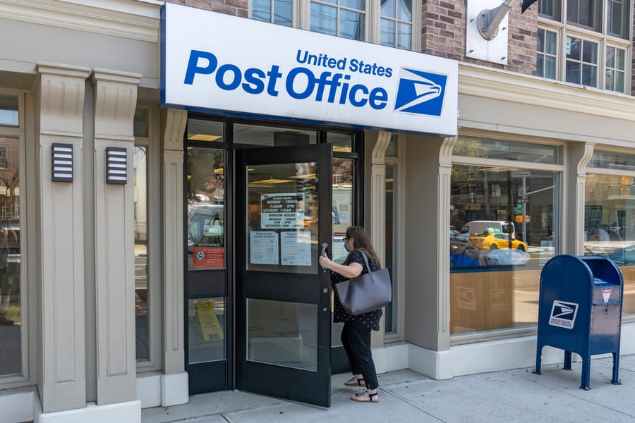 Woman Enters A United States Postal Service