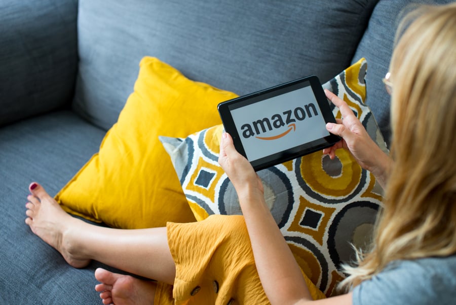 Women Holding Tablet With Amazon Logo