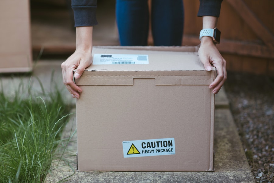 Cardboard Box With A Label &Quot;Caution Heavy Package&Quot;.