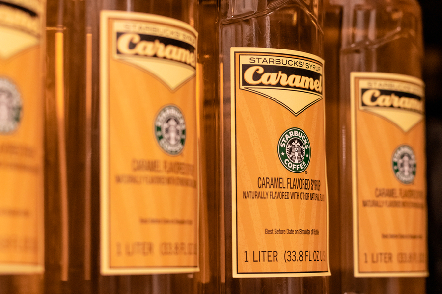 Starbucks Caramel Syrup Bottles Lined Up To Be Served In Beverages