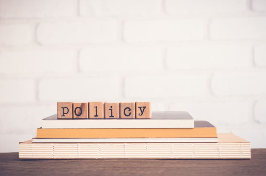 The Word Policy, Alphabet On Wooden Rubber Stamps On Top Of Books And Table