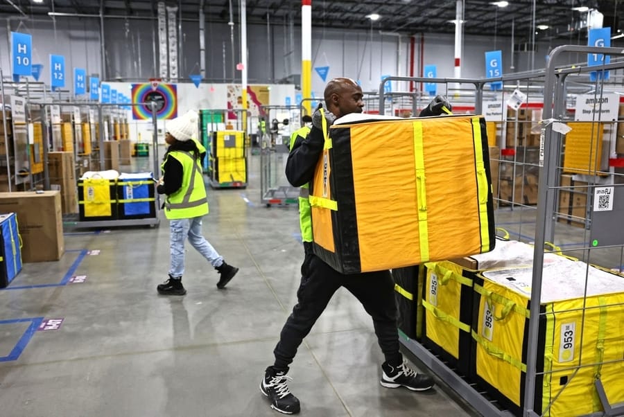 Amazon Workers Move Carts Filled With Packages