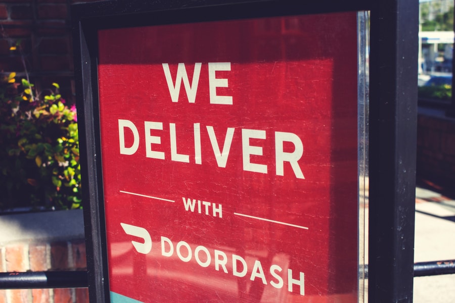 An Advertisement At A Restaurant Offering Food Delivery Service Through The Doordash App