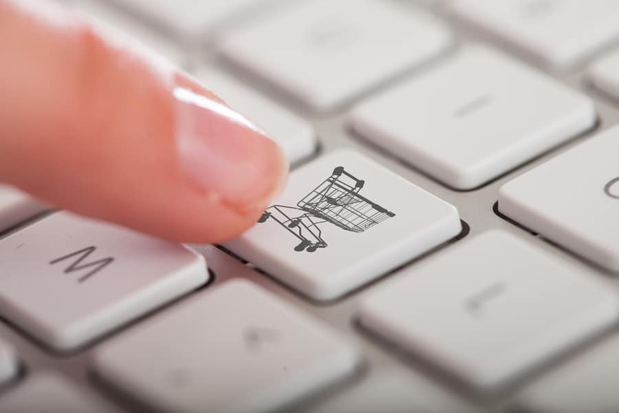Close-Up Photo Of Hands Pressing Buy Button Keyboard