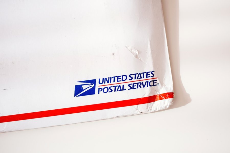 Close-Up View Of Damaged Corner Of United States Postal Service Parcel Envelope