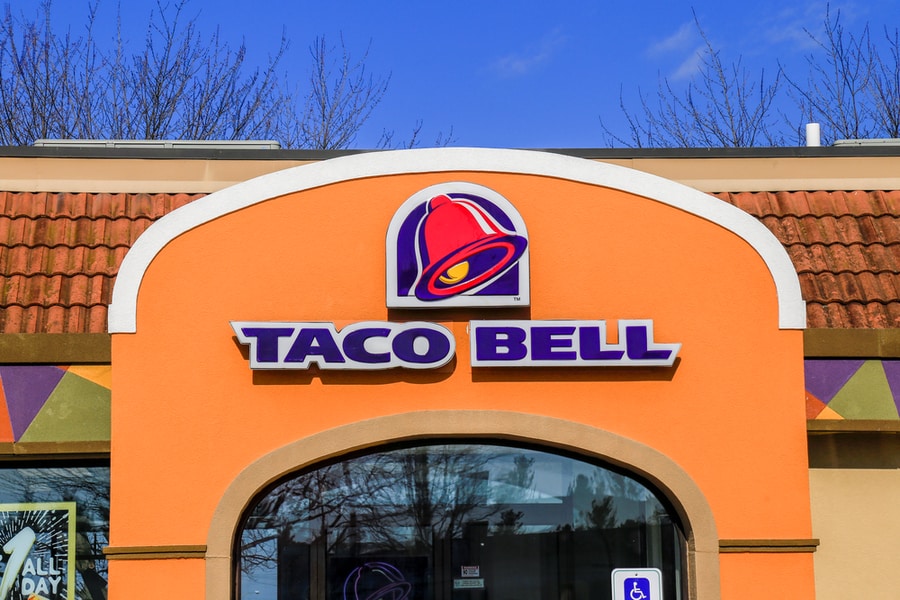 Exterior Of Taco Bell Fast-Food Restaurant With Sign And Logo
