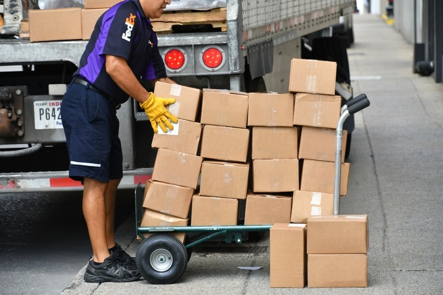Fedex Employee Unloading Boxes For Delivery, Shipping Logistics