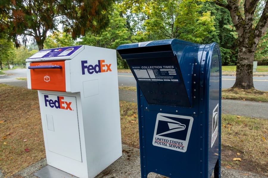 Fedex Package And Letter Deposit Station Next To A Blue Usps Deposit Box