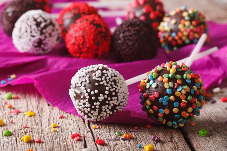 Festive Chocolate Cake Pops With Candy Sprinkles Close-Up On The Table