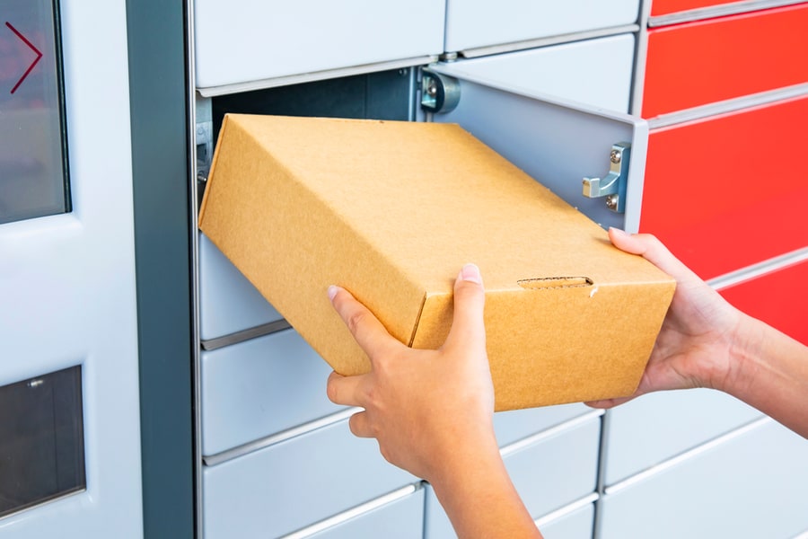 Hand With Parcel At Pickup Point With Lockers