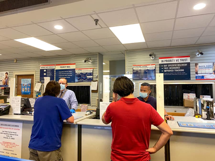 People Mailing Packages At A United States Post Office