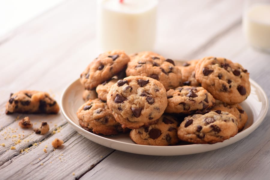 Pile Of Delicious Chocolate Chip Cookies On A White Plate