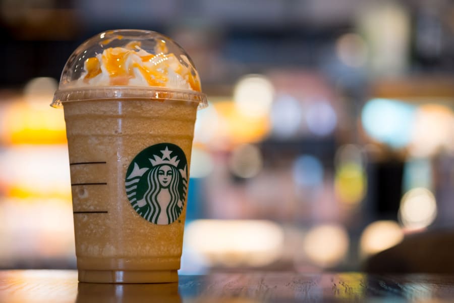 Starbuck Coffee Frappuccino On Table, Famous Coffee Brand Franchise Originated In Usa