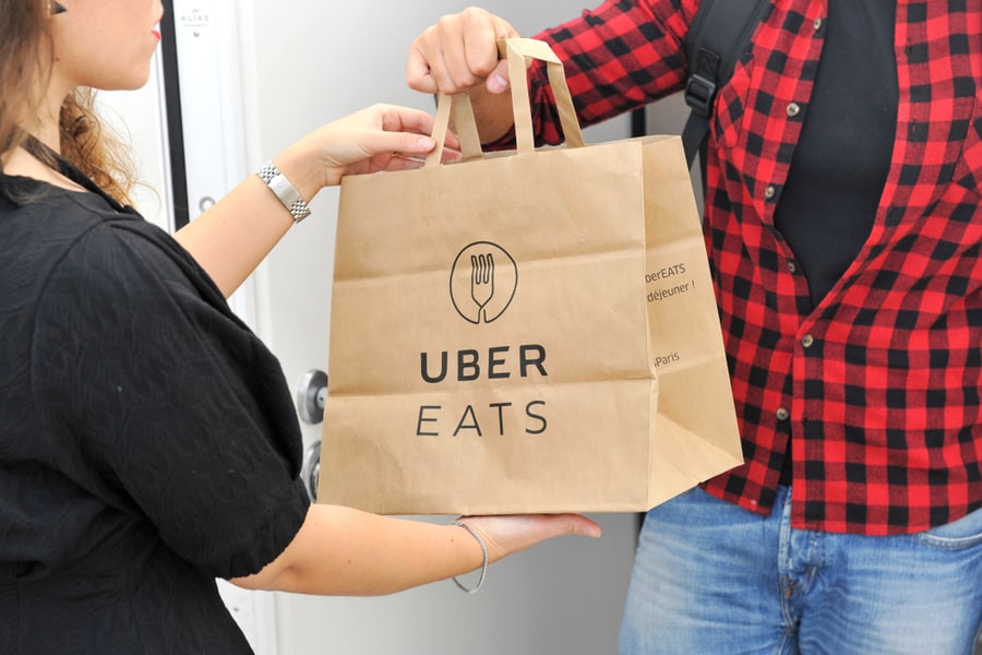 Uber Eats Home Delivery - You Can Order Food From The Restaurant And Eat It At Home, At Work Or In Other Places - Lady Gets The Food In A Bag