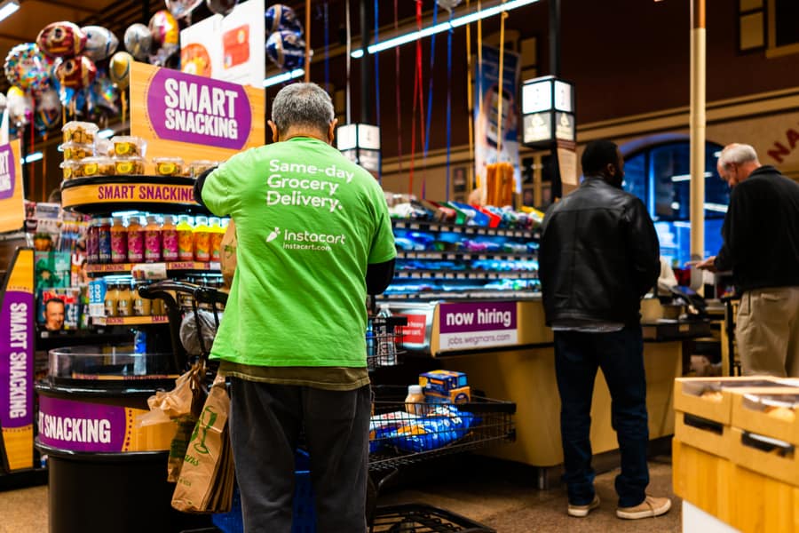 Wegmans Grocery Store Interior With Checkout Counter And Instacart Man Worker And Sign On Shirt For Same-Day Delivery