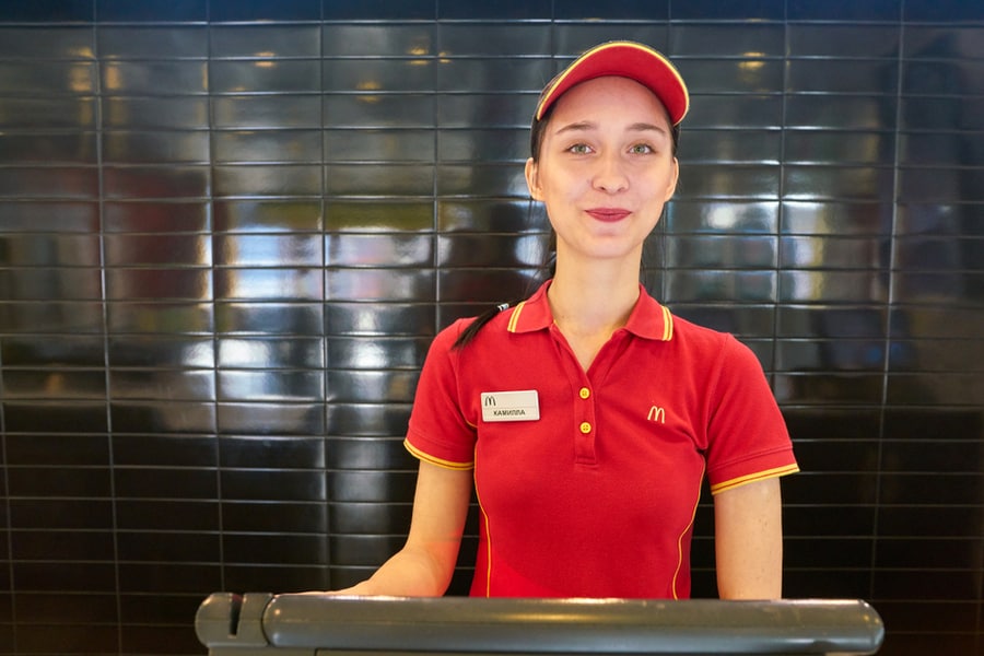 Worker In Mcdonald's Restaurant. Mcdonald's Is An American Fast Food Company.