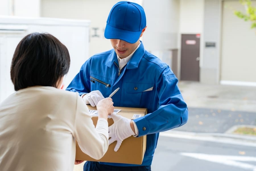 A Delivery Person Is Handling The Package