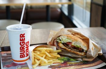 Burger King Cola Cup, Potato French Fries And Whopper Hamburger In Burger King Restaurant. Burger King Is A Global Chain Of Hamburger Fast Food Restaurants