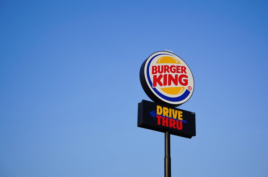 Burger King Drive Thru Outdoor Billboard Against Blue Sky. Burger King Is A Global Chain Of Hamburger Fast Food Restaurants.