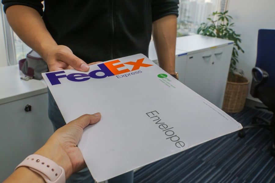 Close Up Business Woman Receive Envelope From Fedex Express Courier By Hand