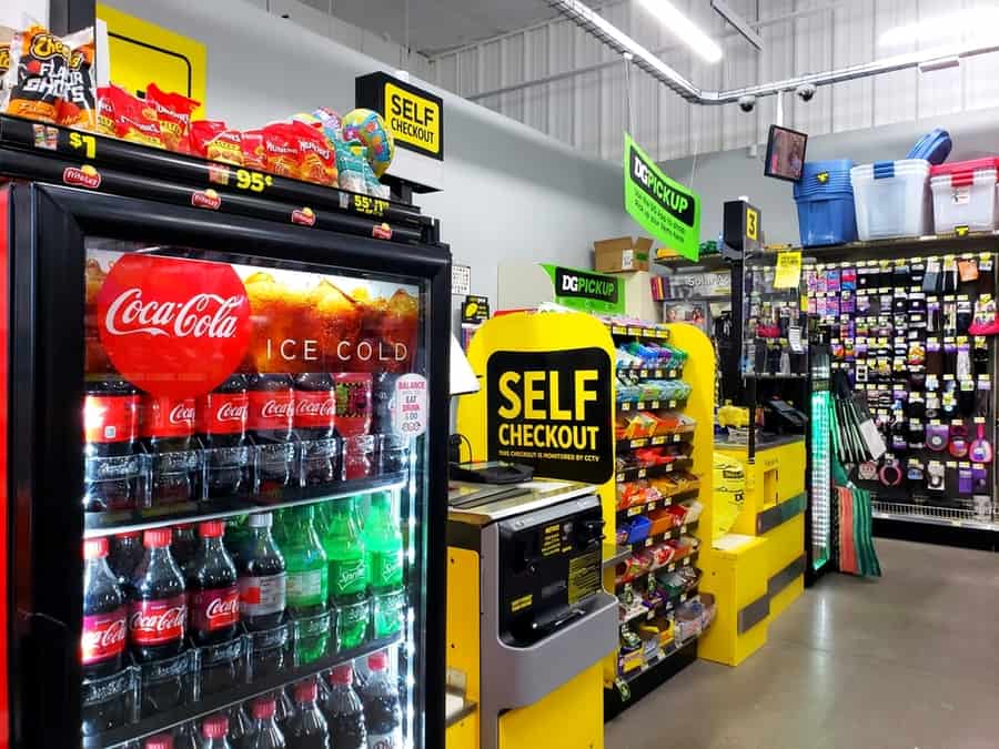 Dollar General South - Self Checkout Next To A Coca Cola Fridge