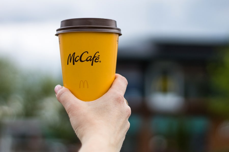 Girl Holding A Cup Of Mccafe Coffee From Mcdonald's Fast Food Restaurant.