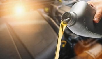 Hand Pouring Oil To Car Engine