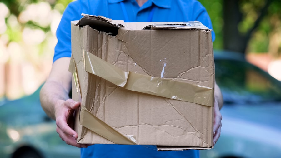 Male Courier Showing Damaged Box