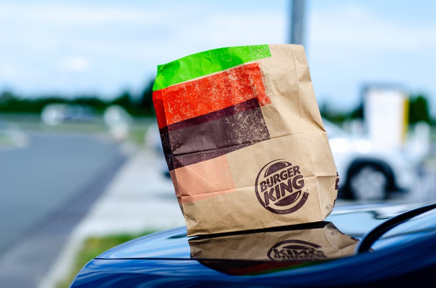 Paper Packaging With An Order From Burger King On A Car
